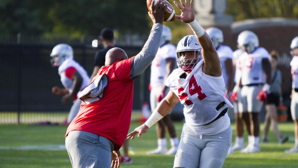 Defensive line coach Larry Johnson and defensive end J.T. Tuimoloau